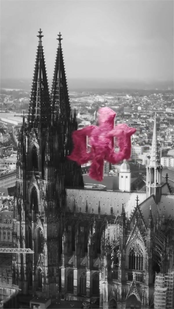 A Quick Buck Pink Fuzzy Logo Floats Above Cologne Cathedral