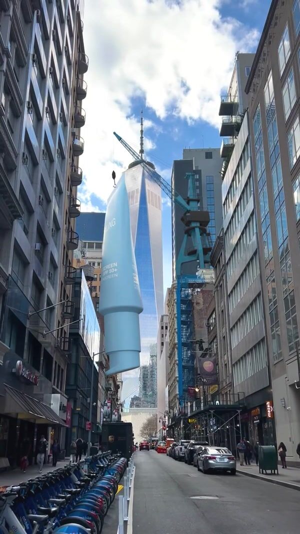 Darling Crane Lowers Sunscreen onto the Street