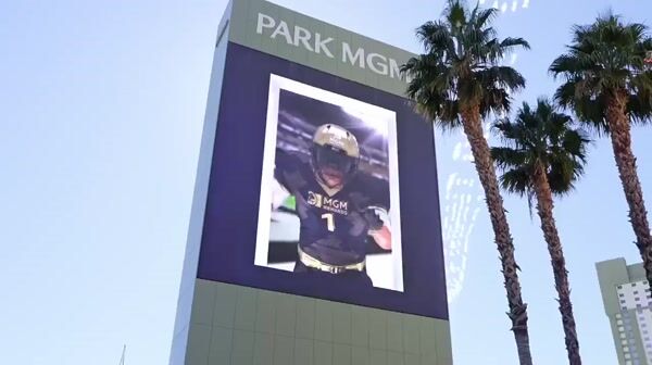 MGM Football Player Leans Out of Screen