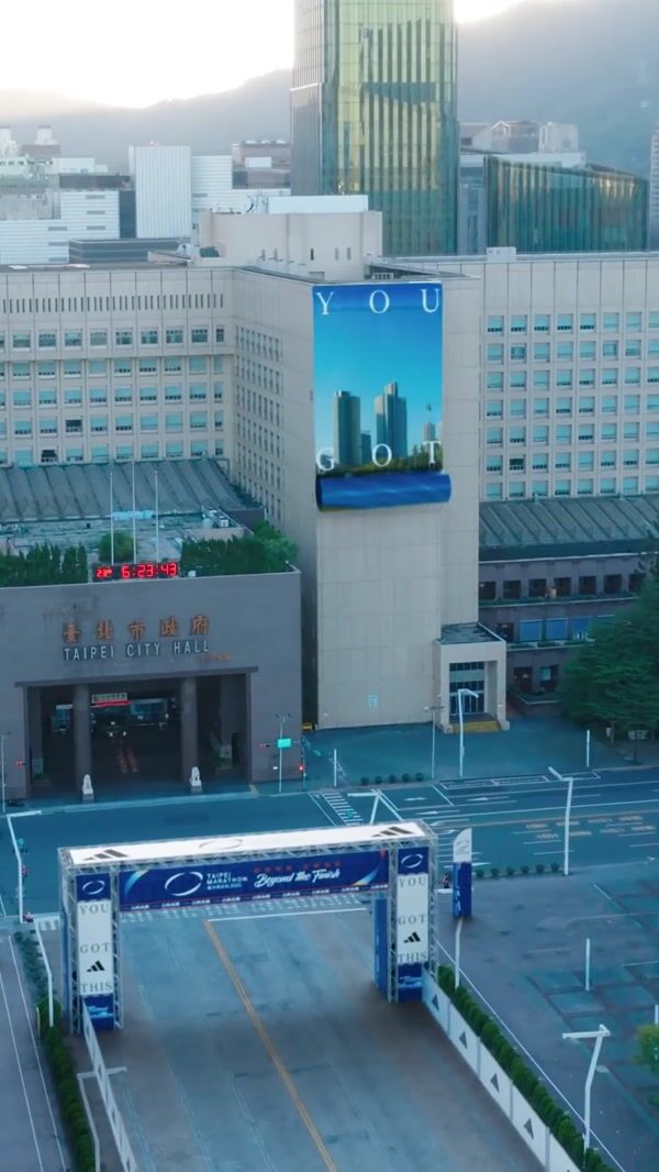 Adidas Giant Shoe Emerges from Banner