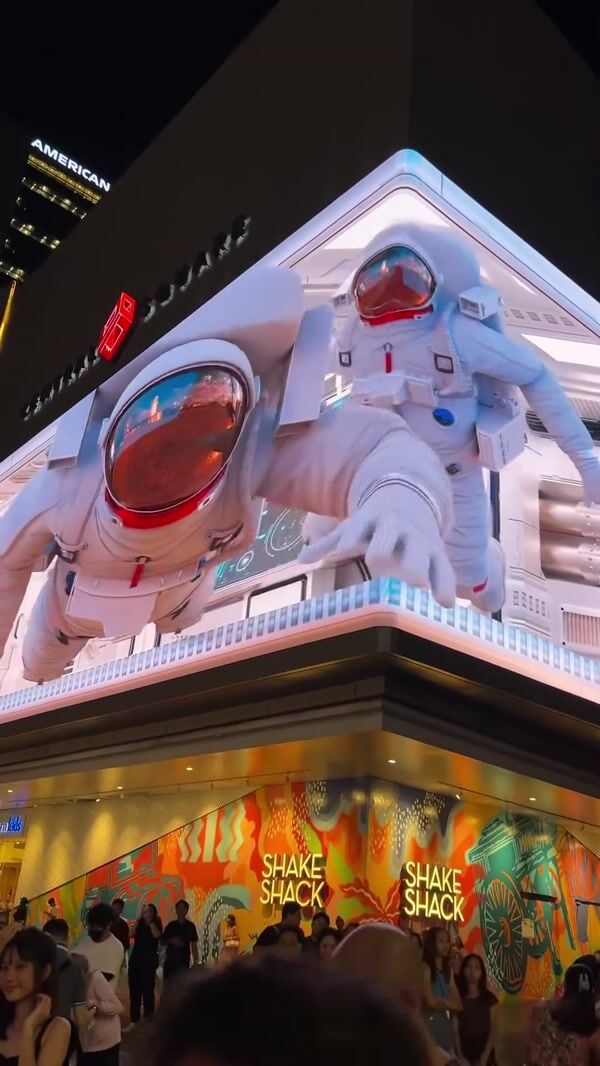 Astronaut Floats Across Billboards