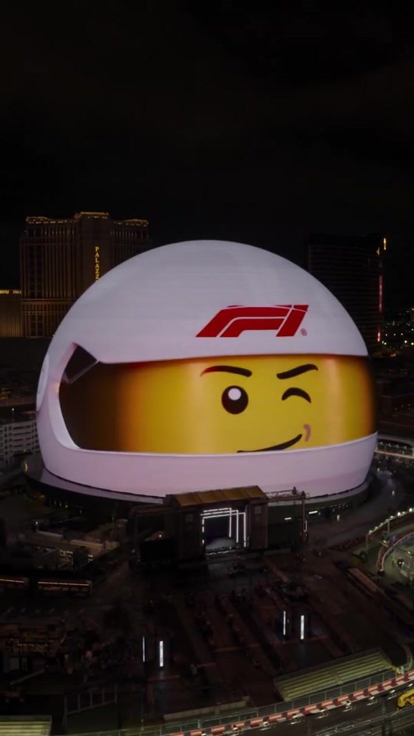 LEGO Emmet Drives F1 Cars Across Sphere