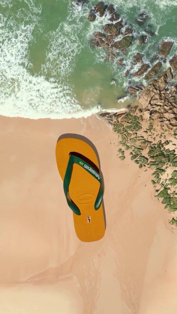 Havaianas Man Sunbathing Above Giant Sandal