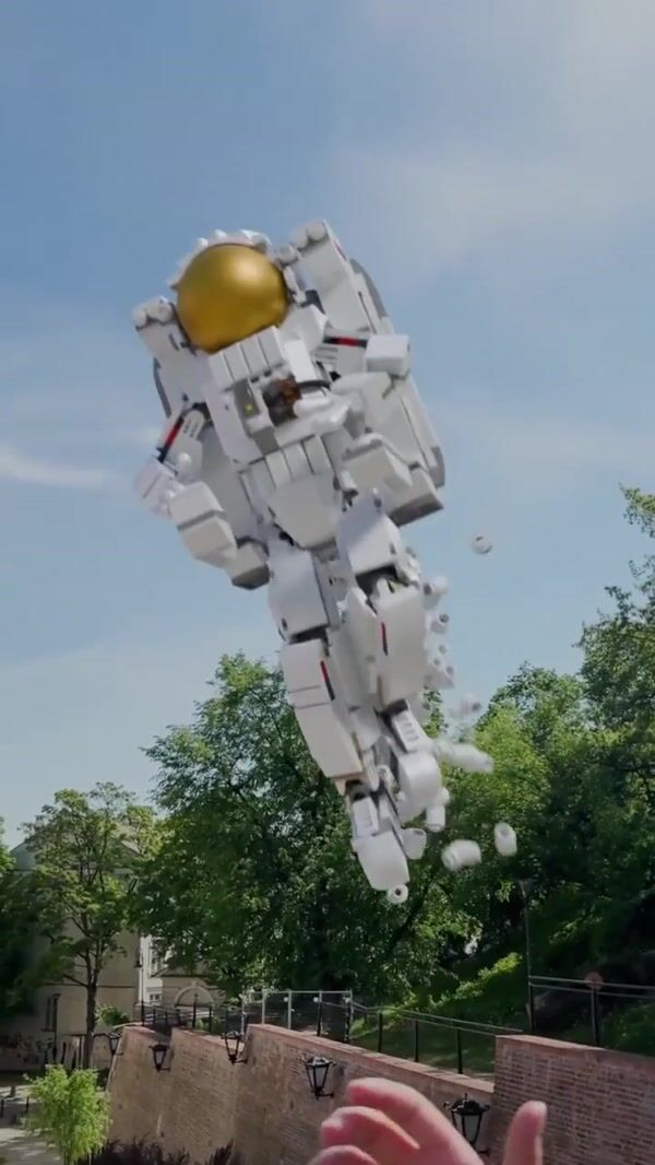 LEGO Astronaut Grabbed by Hand in Billboard