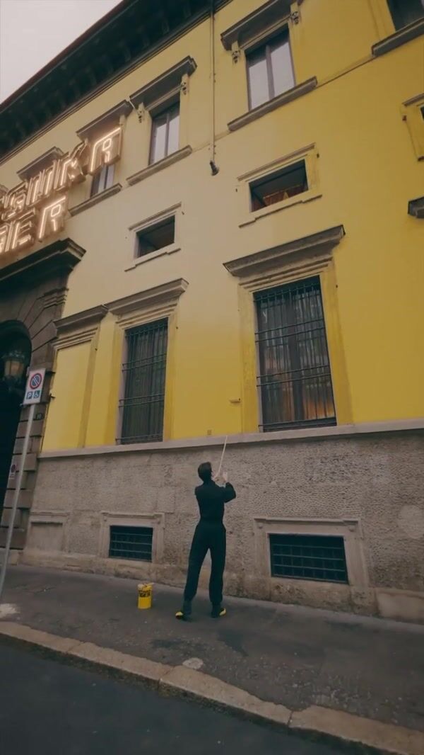 Onitsuka Tiger Man Paints Building Yellow