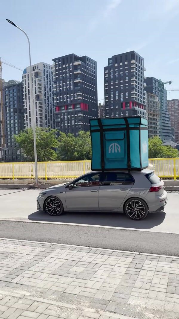 Alula Eating House Giant Wolt Box Atop Car