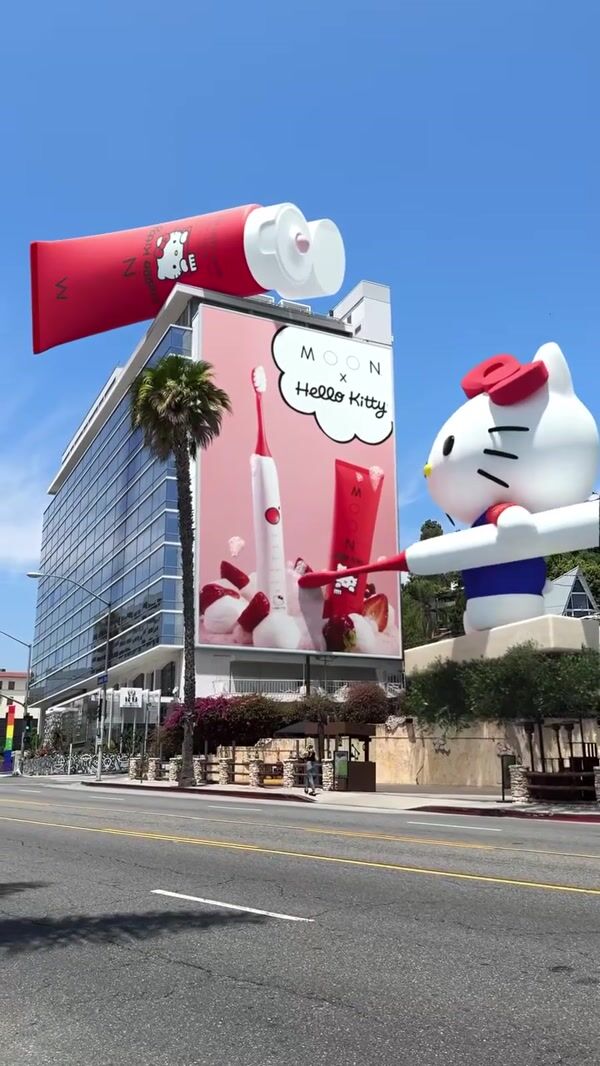 MOON Hello Kitty Holding Electric Brush on Building