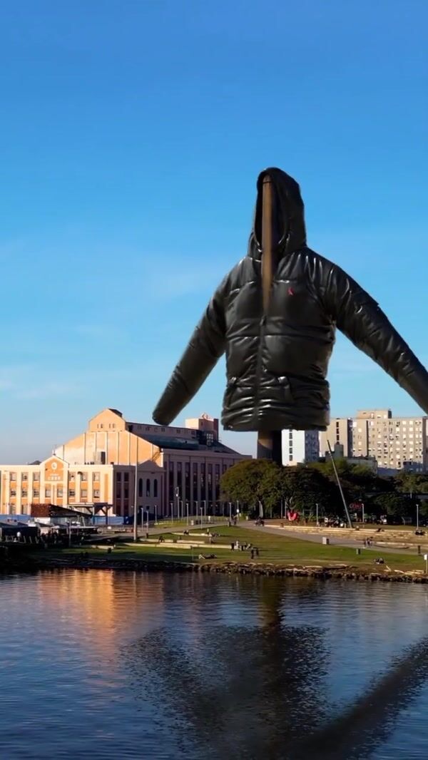 Reserva Black Jacket Hanging from Industrial Chimney