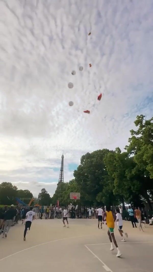 Puma Sneakers and Basketballs Rain Over Eiffel Tower Court