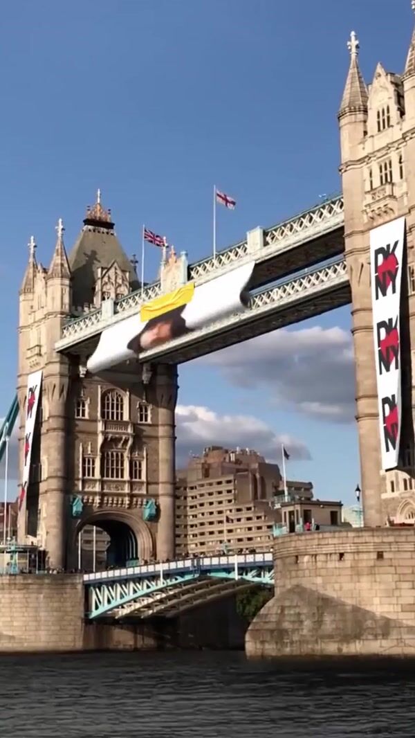 DKNY Model’s Poster Rolls Down on Bridge