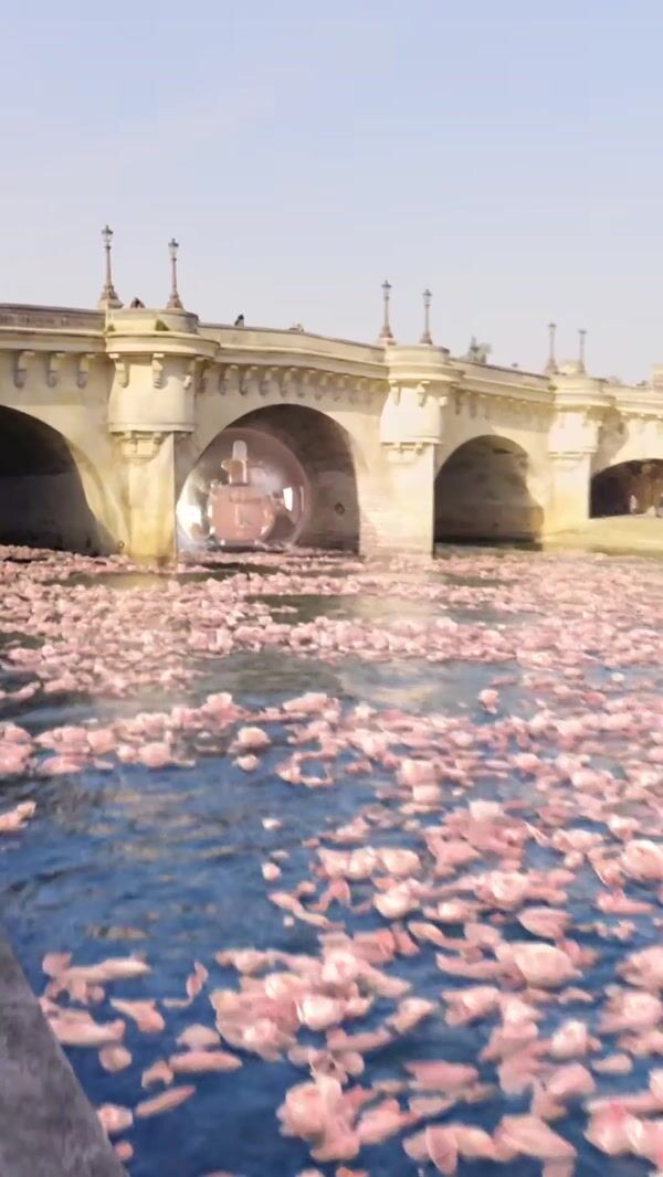 Kérastase Hair Oil Bottle Floats in Flower-filled River