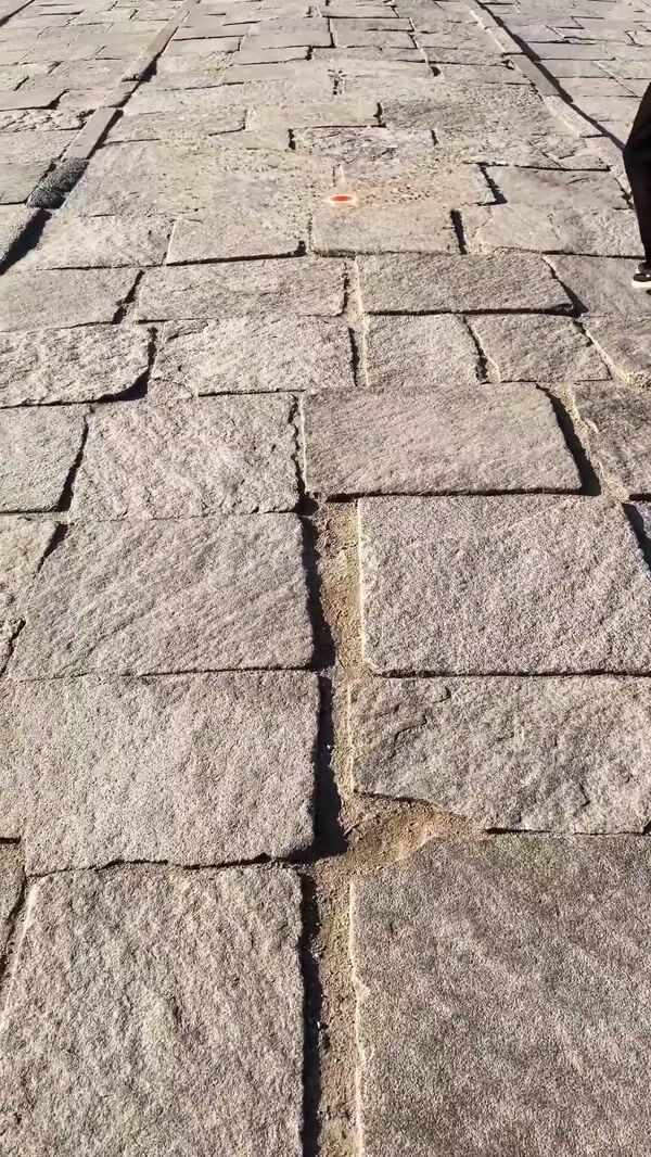 Superman Logo Appears on Cobblestone Street