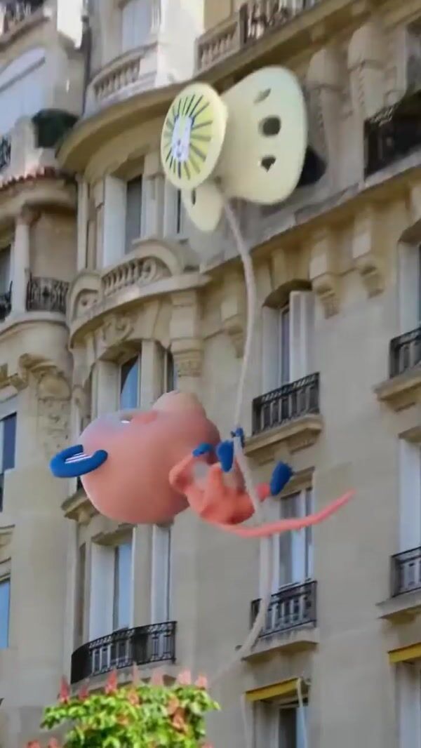 Biolane Monkey Mascot Gets Pacifier Atop the Arc de Triomphe