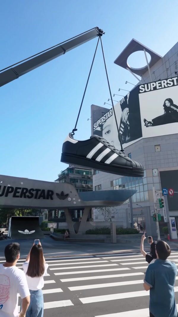 Adidas Giant Shoe Skateboards Through City