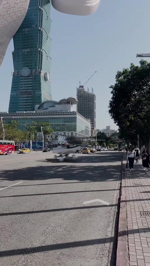 Unknowndomain Giant Sneakers Float by Taipei 101