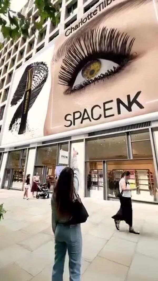 Space NK Giant Mascara Applied to Eye on Billboard