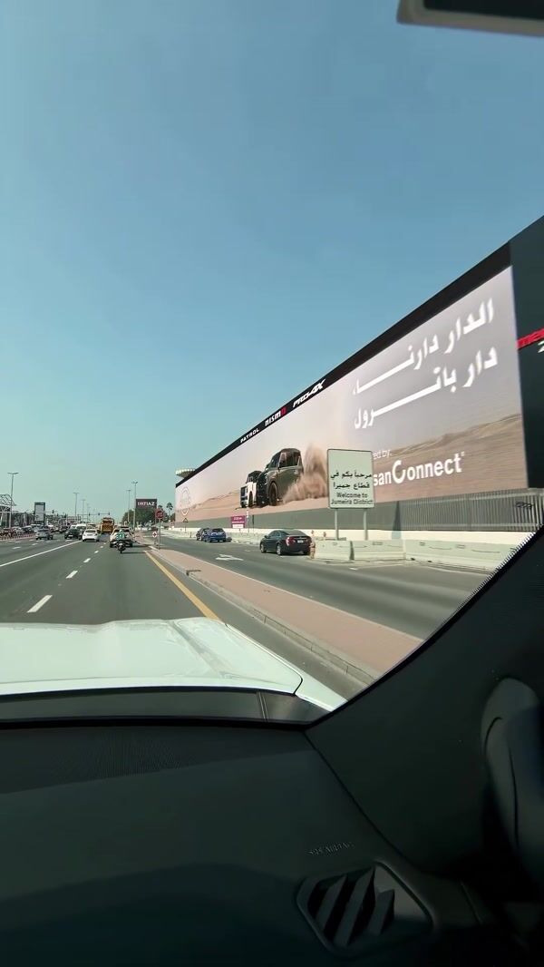 Nissan Cars Kick Up Sand From Billboard