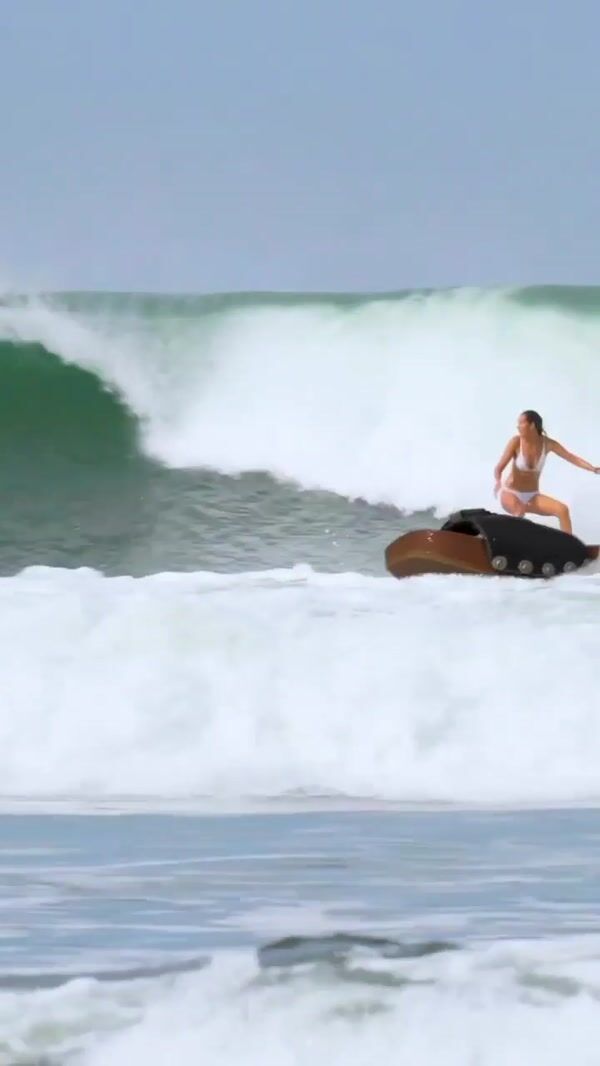 RE/DONE Woman Surfs on Giant Sandal