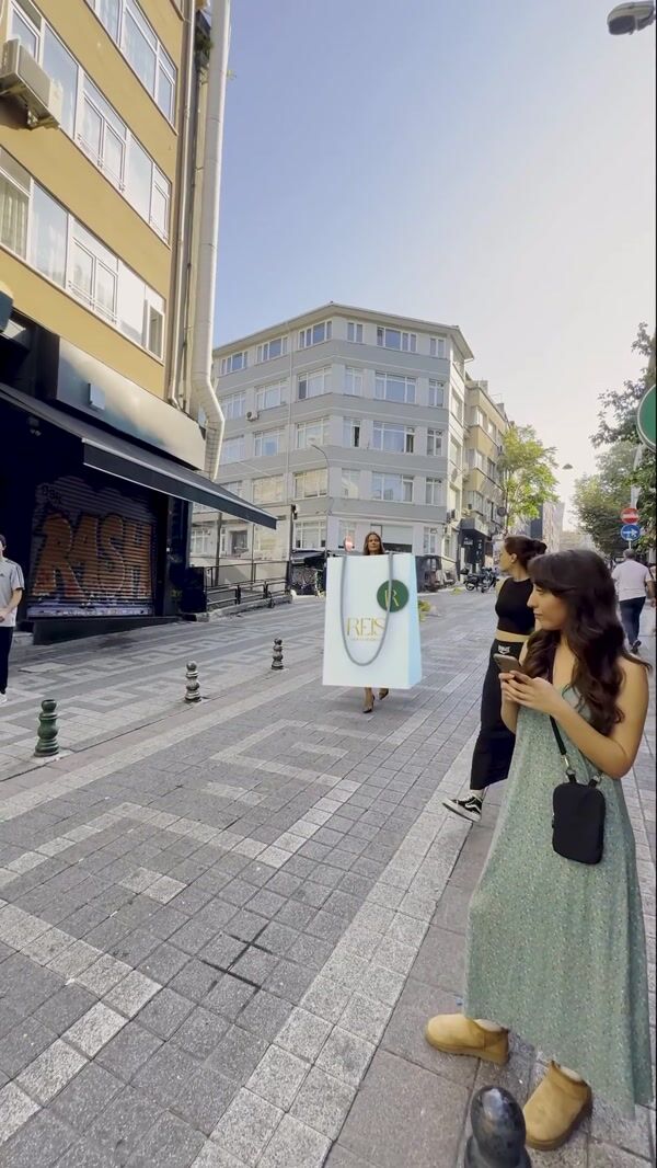 Reis Woman in Giant Shopping Bag
