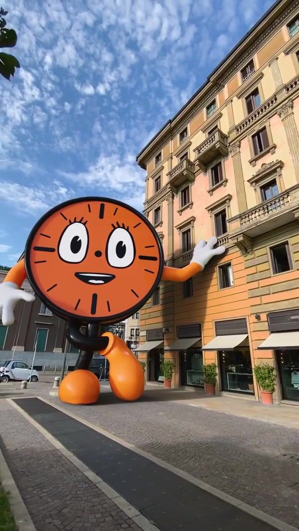 Marvel Clock Mascot Stands Beside Building