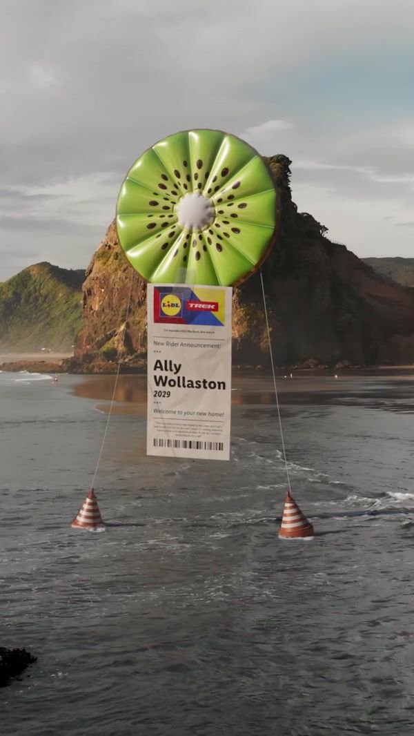 Large Kiwi balloon floats above Piha Beach, New Zealand
