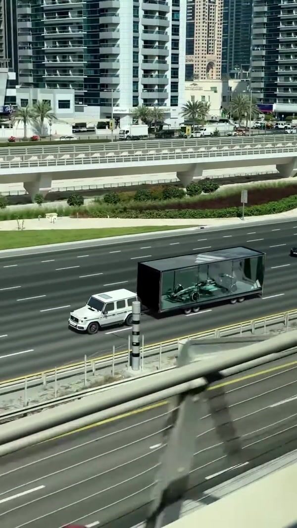Adidas Race Car Rides Car Carrier on Highway