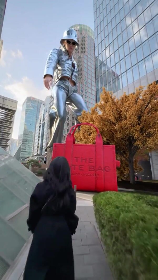 Marc Jacobs Giant Model Picks Up Red Tote Bag