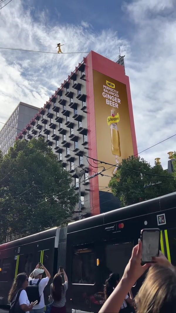 Schweppes Woman Balances on Tightrope