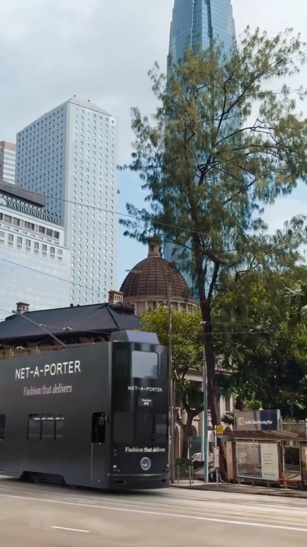 NET-A-PORTER Double-decker Bus Unloads Black Boxes