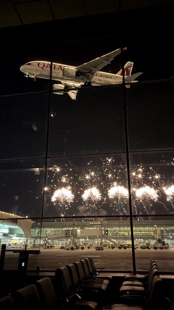 Qatar Airways Plane Flying Over Fireworks