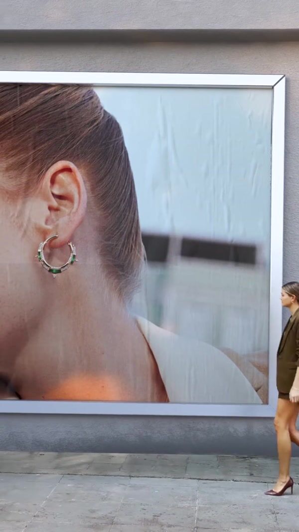 Reis Woman Takes Giant Earring From Billboard