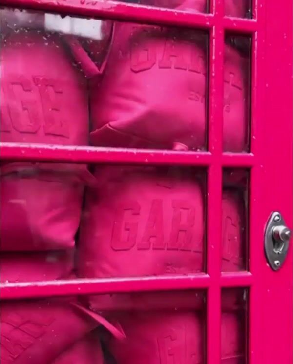 Garage Telephone Booth Overflows with Tote Bags