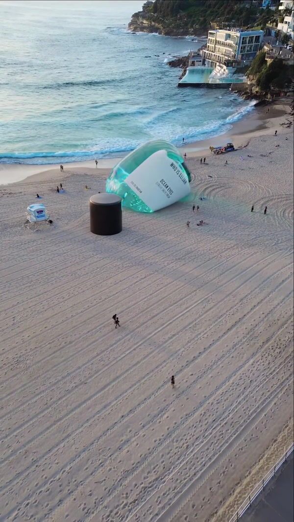 Who is Elijah Giant Inflated Perfume Bottle on Beach Shoreline