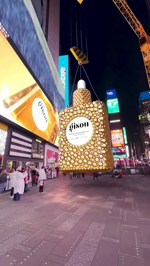 Gisou Hair Oil Bottle Lowered by Crane