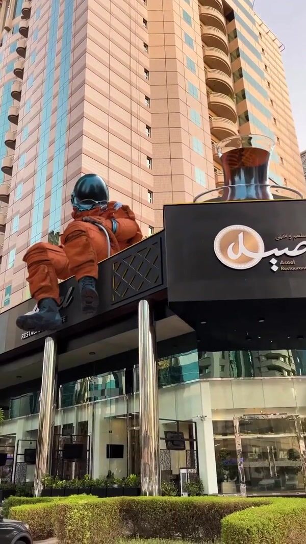 Aseel Restaurant Astronaut Sitting on Cafe Rooftop
