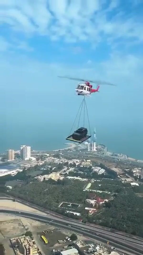 Cadillac Helicopter Transports Car Outside Showroom