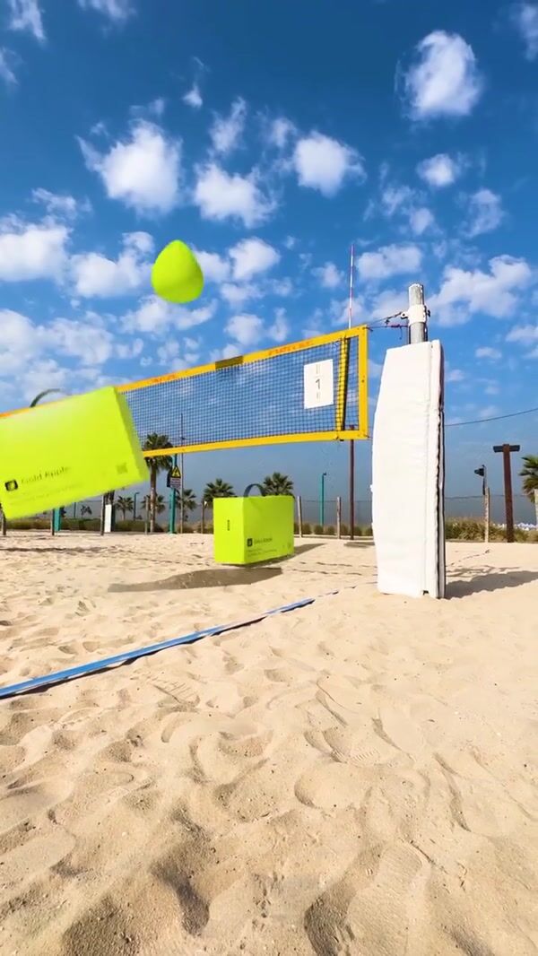 Gold Apple Giant Boxes Play Beach Volleyball