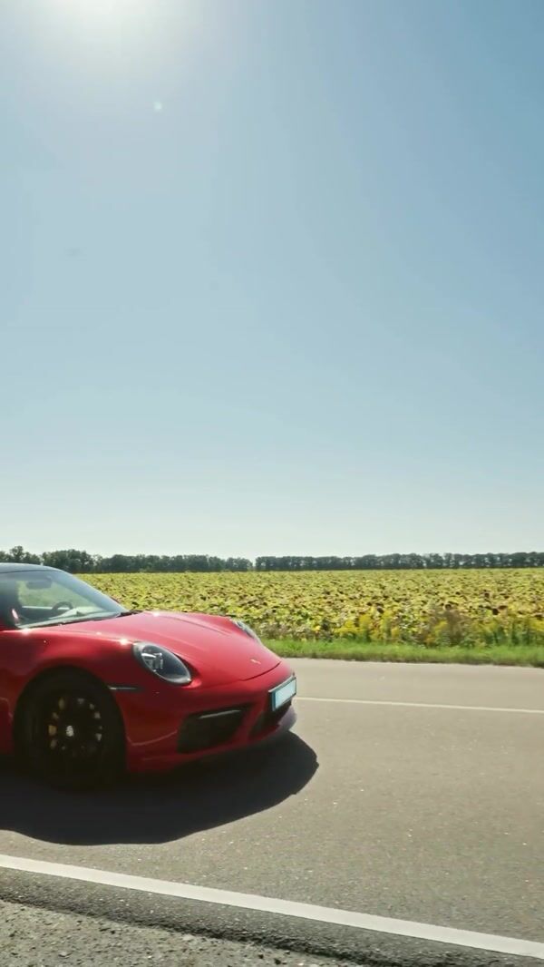 Mitas Giant Tire Passes Over Sports Car