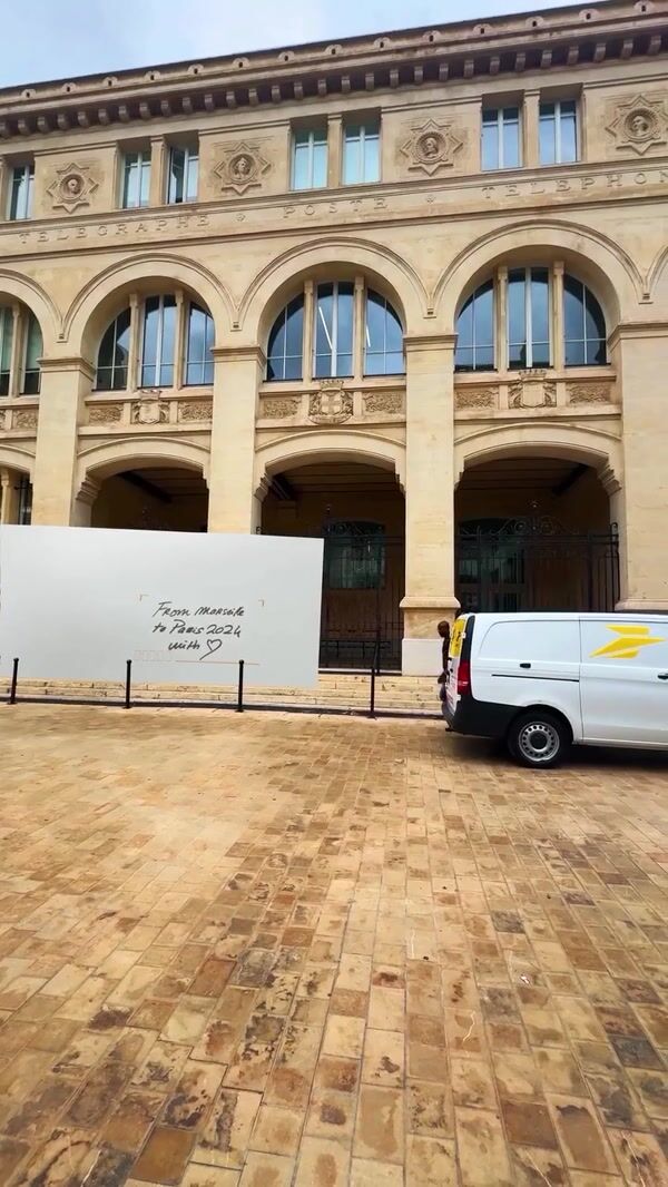 La Poste Crews Put Post Stamp on Envelope